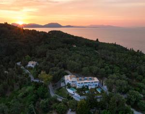 an aerial view of a house on a hill with the sunset at Playia Villas III in Petrití