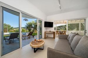 a living room with a couch and a table at Playia Villas III in Petrití