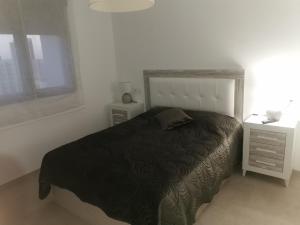 a bedroom with a black bed and a night stand at Apartamento Justina 2 in Los Mártires +18 photos