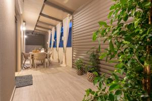 a dining room with a table and some plants at Vedi Town Luxury Apartment in Zakynthos