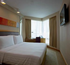 Tempat tidur dalam kamar di Stanford Hotel Hong Kong