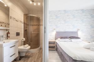 a bathroom with a bed and a shower and a sink at Jakubowa Polana - pokoje in Łeba +43 photos