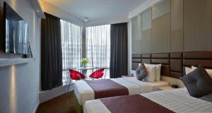 Voodi või voodid majutusasutuse Stanford Hotel Hong Kong toas +37 fotot