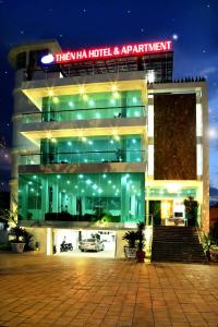 a building with a car garage at night at Thien Ha Hotel & Apartment in Ho Chi Minh City