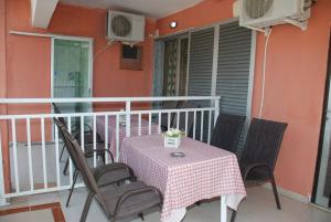 a table and chairs on the balcony of a house at VILLA STATHIS in Nea Vrasna