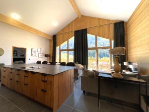 eine Küche mit einer großen Insel in einem Zimmer mit Stühlen in der Unterkunft Les Terrasses de la Vanoise in Champagny-en-Vanoise