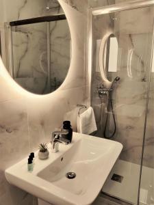 a bathroom with a sink and a mirror at SouthShore Accommodation in Marsaskala +49 photos