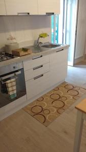 a kitchen with a sink and a stove at Nial House in Monopoli