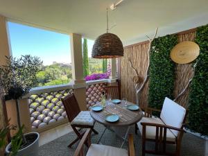 a patio with a table and chairs and a window at Cap Estérel Rivièra Studio in Saint-Raphaël