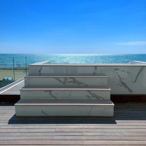 a set of stairs with the ocean in the background at Park Hotel Cellini in Lido di Jesolo