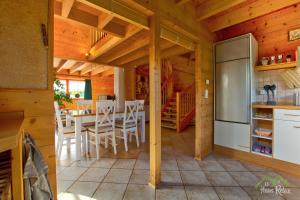 a kitchen and dining room with a table and a refrigerator at haus-relax - no business b00king - no fitters in Bittstädt