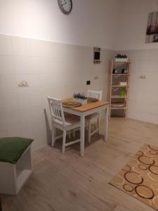 a room with a table and a chair and a clock at Nial House in Monopoli +15 photos