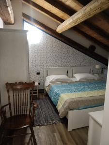 a bedroom with a bed and a chair and a table at Agriturismo Helianthus in Oleggio