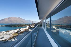 a balcony with a view of the water and mountains at Star Lane by Amazing Accom in Queenstown