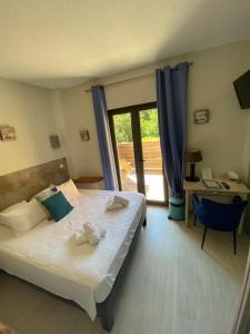 a bedroom with a bed and a desk and a window at Le Belvedere in Vallon-Pont-dʼArc +37 photos