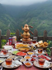 a table full of food and a teapot at Elabay Dağ Evleri in Çamlıhemşin