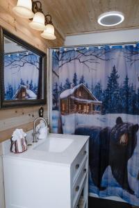 a bathroom with a shower with a bear shower curtain at Remodelled cabin! great location! in Sevierville +25 photos