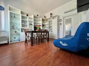 a living room with a dining room table and chairs at villino Morena in Torre del Lago Puccini +33 photos