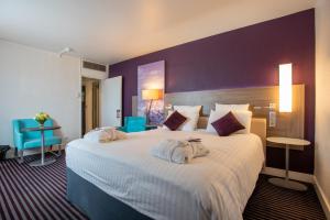 a hotel room with a large bed with towels on it at Mercure Marseille Centre Vieux Port in Marseille