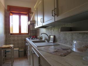 a kitchen with a sink and a counter top at Casa il Giovane Alloro in Martina Franca