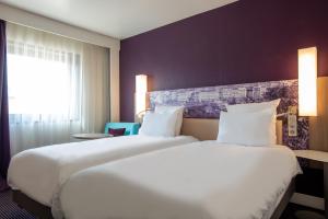 a hotel room with two beds and a window at Mercure Marseille Centre Vieux Port in Marseille