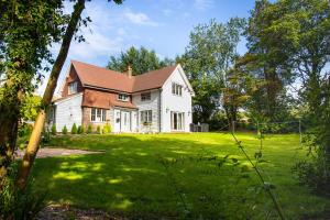 a large white house with a grass yard at Inviting 5-Bed House in 1066 County - Battle in Battle