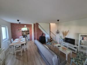 a living room with a couch and a table at HOOPOVO HOUSE Fruška gora in Irig