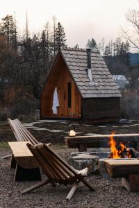 a log cabin with a fire in front of it at Apres Whitefish in Whitefish