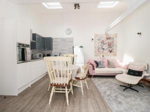 a living room with a table and chairs and a couch at The Stables in Winscombe