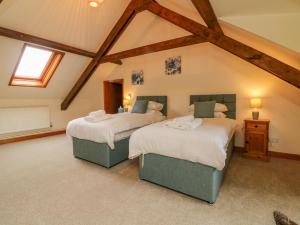 Ένα ή περισσότερα κρεβάτια σε δωμάτιο στο Elsworthy Farm Cottage