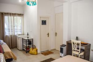 a small room with a bed and a white door at BONSAI in Skiathos