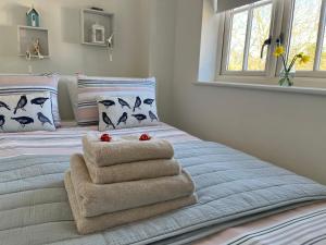 a bedroom with a bed with towels on it at Whitstable The Jolly in Whitstable +37 photos
