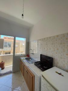 uma cozinha com um fogão e uma bancada em PROMO Appartement Familial avec WiFi em Al Hoceïma