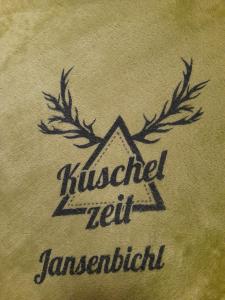 a label on a shirt with a picture at Appartement Kuschelzeit Jansenbichl in Wagrain