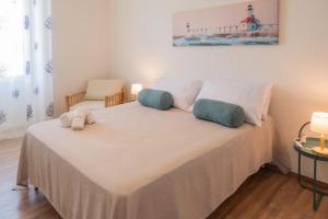 a bedroom with a bed with two pillows on it at Biggy Apartment in Olbia