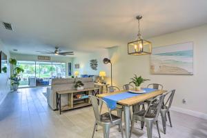 a dining room and living room with a table and chairs at Jensen Beach Home with Private Dock and Ocean Access! in Jensen Beach