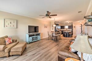 a living room with a couch and a tv at Lakefront Corsicana Condo with Balcony and Pool Access in Corsicana