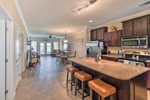 a kitchen with a large island with bar stools at Lakefront Corsicana Condo with Balcony and Pool Access in Corsicana