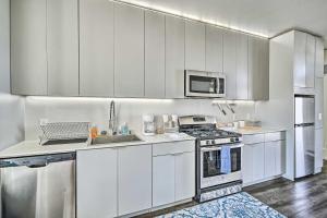 a kitchen with white cabinets and stainless steel appliances at Berkeley Apt with Rooftop 4 Blocks to Campus! in Berkeley