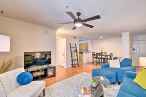 a living room with blue furniture and a ceiling fan at 6 Mi to Downtown Phoenix Condo with Pool Access! in Phoenix