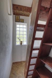 a wooden staircase in a room with a window at Apartman Tina in Grižane