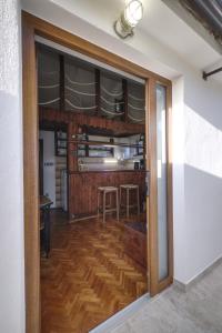 an open door into a kitchen with wooden floors at Apartman Tina in Grižane