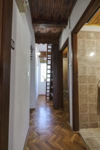a hallway with wood floors and a wooden ceiling at Apartman Tina in Grižane