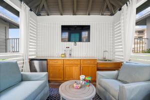a kitchen with two chairs and a table in a room at Calypso Resort Tower 3 by Panhandle Getaways in Panama City Beach