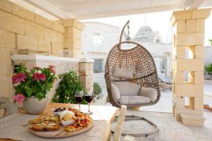 a table with a plate of food and glasses of wine at Trullo Arteanima in Locorotondo