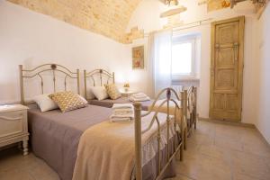 Postel nebo postele na pokoji v ubytování Trullo Arteanima