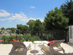 two chairs and a table on a patio at Villa Il Giovane Alloro in Martina Franca
