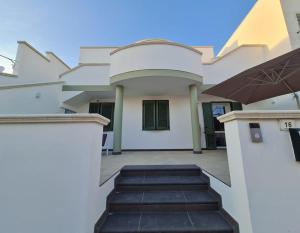 a house with a staircase leading to the front yard at 180Passi B&B in Lido Marini