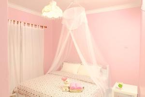 a childs bedroom with a bed with a canopy at The Big Bear Home in Melaka