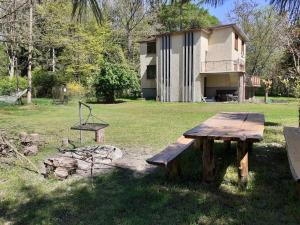 a wooden picnic table in front of a house at Zwolaki in Ulanów